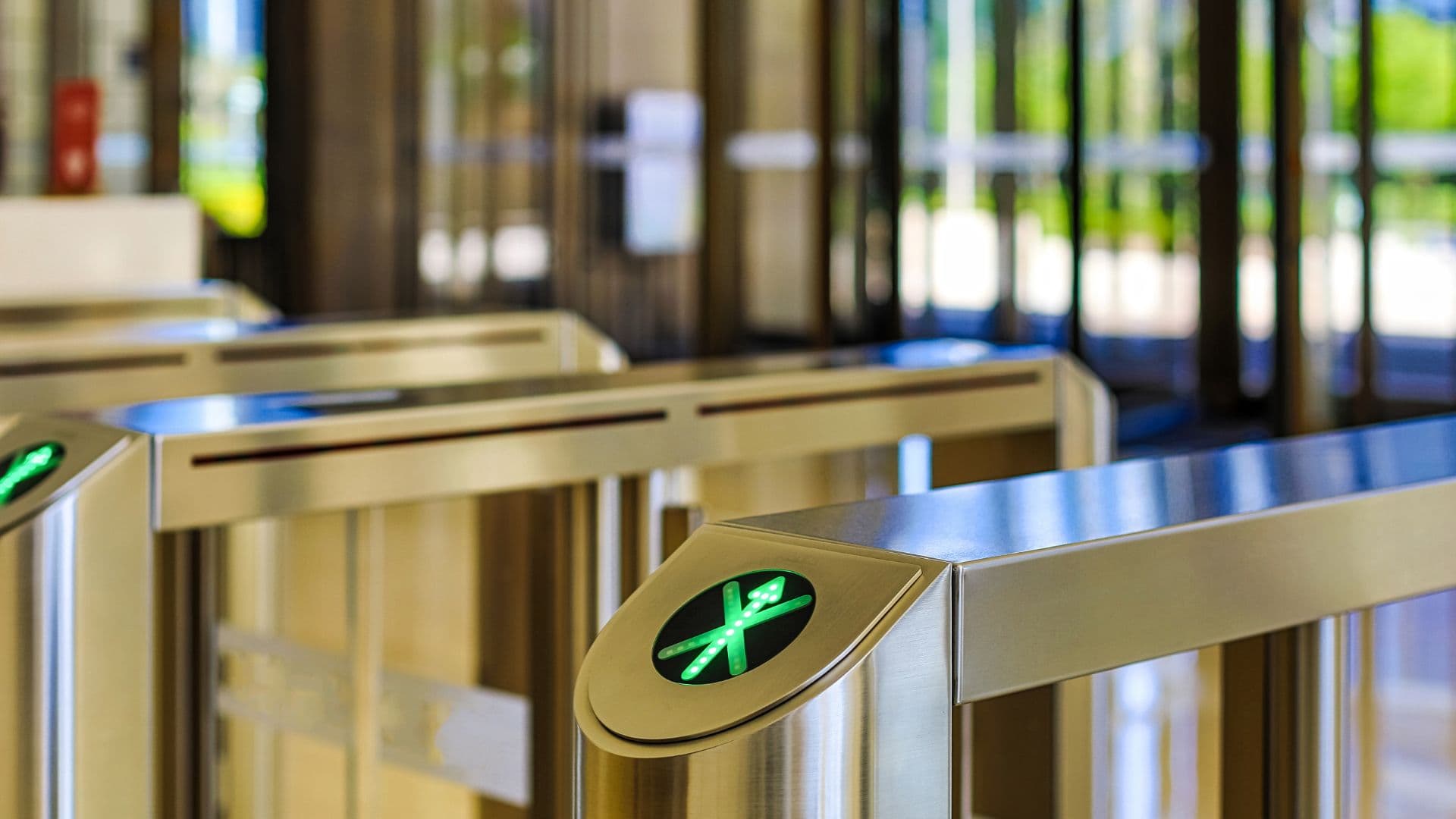 Access gates at the entrance to a lobby, showing a green go signal.